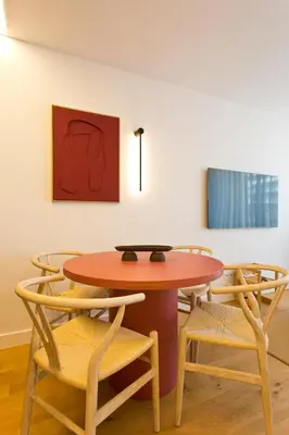 a table and chairs in a room with a painting at Porto - Boavista Casa Da Música- Art Gallery Apartment III in Porto