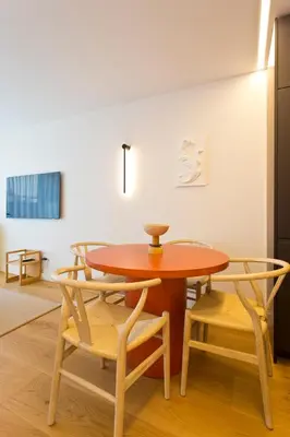 a table and chairs in a room with a wall at Porto - Boavista Casa Da Música- Art Gallery Apartment III in Porto