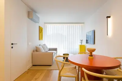 a living room with a table and chairs and a couch at Porto- Boavista Casa Da Música - Art Gallery Apartment II in Porto