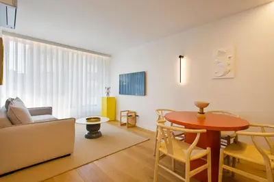a living room with a table and a couch at Porto- Boavista Casa Da Música - Art Gallery Apartment II in Porto