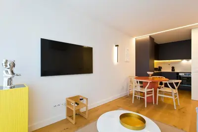 a living room with a flat screen tv on the wall at Porto- Boavista Casa Da Música - Art Gallery Apartment II in Porto