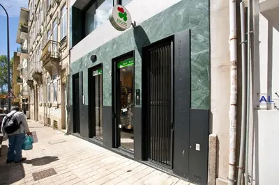 a woman walking down a street in front of a store at Porto- Boavista Casa Da Música - Art Gallery Apartment II in Porto