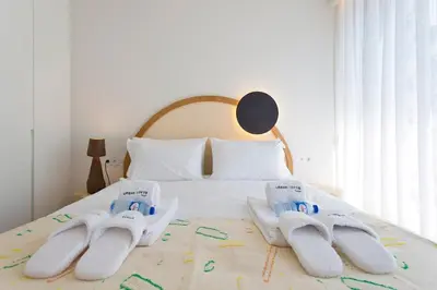 a bedroom with a bed with towels on it at Porto- Boavista Casa Da Música - Art Gallery Apartment II in Porto