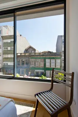 a bench sitting in front of a window at Porto- Boavista Casa Da Música - Art Gallery Apartment II in Porto