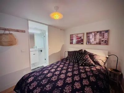a bedroom with a bed with a black and white comforter at Casa dos Moinhos - Country House in Porto City in Porto