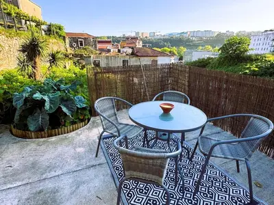 a small table and chairs on a patio at Casa dos Moinhos - Country House in Porto City in Porto
