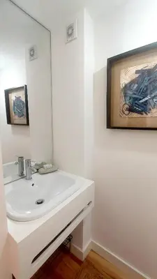 a bathroom with a white sink and a mirror at Casa dos Moinhos - Country House in Porto City in Porto