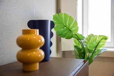two vases sitting on a table next to a plant at GuestReady - Cheerful place in Porto in Porto