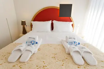 a bedroom with a bed with white socks on it at Porto - Boavista Casa Da Música - Art Gallery Apartment I in Porto