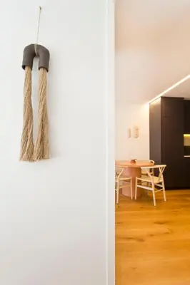 a living room and dining room with a rope hanging from the wall at Porto - Boavista Casa Da Música - Art Gallery Apartment I in Porto