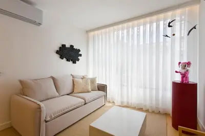 a living room with a couch and a window at Porto - Boavista Casa Da Música - Art Gallery Apartment I in Porto