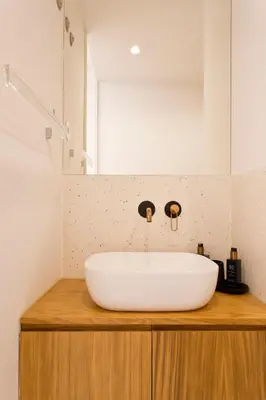 a white sink on a wooden counter in a bathroom at Porto - Boavista Casa Da Música - Art Gallery Apartment I in Porto