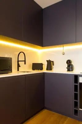 a kitchen with black cabinets and a sink at Porto - Boavista Casa Da Música - Art Gallery Apartment I in Porto