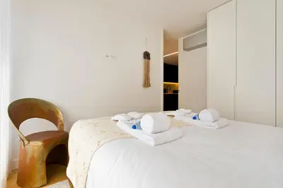 a bedroom with a bed with towels on it at Porto - Boavista Casa Da Música - Art Gallery Apartment I in Porto