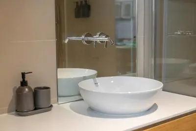a bathroom with a white sink and a shower at Modern 1BR Apartment - Brand New Bonjardim F in Porto