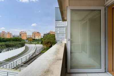 a door to a balcony with a view of a city at GuestReady - Cosy Studio Near Arrábida Shopping in Vila Nova de Gaia