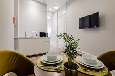 a dining room with a table and chairs at Plaza - Charming GuestHouse in Porto