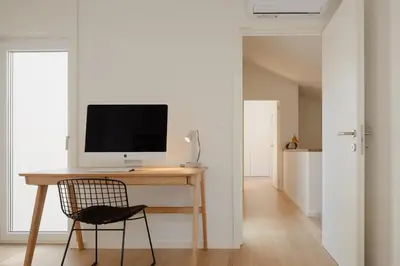 a desk with a computer on it in a room at Volta do Patio in Porto