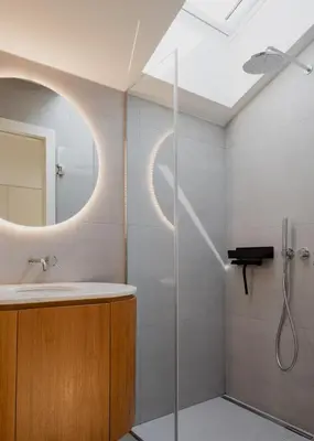 a bathroom with a shower and a sink and a mirror at Volta do Patio in Porto