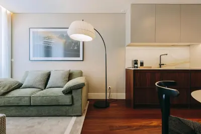 a living room with a couch and a floor lamp at Gran Cruz Apartments in Vila Nova de Gaia