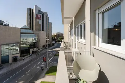 a table and chairs on a balcony with a view at Bom Sucesso Executive Flats by Feel Porto in Porto