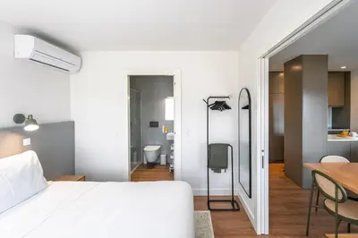 a living room with a couch and a tv at Bom Sucesso Executive Flats by Feel Porto in Porto