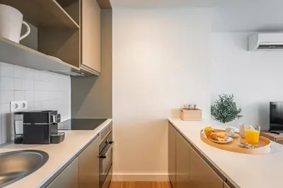 a kitchen with a plate of food on a counter at Bom Sucesso Executive Flats by Feel Porto in Porto