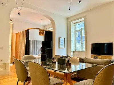 a living room with a table and a couch at Paraíso Garden Apartments in Porto