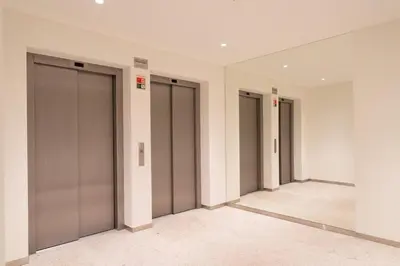 a row of elevator doors in a building at Stylish Formosa Studio by HostWise in Porto