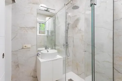 a bathroom with a sink and a glass shower at Authentic Retreat by HostWise in Porto