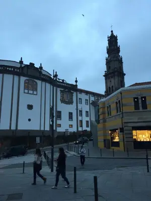 a group of people walking down a street with a building at Miguel Bombarda - Porto Houses & Suites in Porto