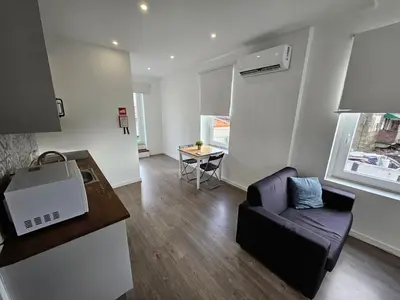 a living room with a couch and a table at Antas Place B in Porto