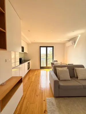 a living room with a couch and two chairs and a table at Flores Street Apartment - Porto City Center in Porto