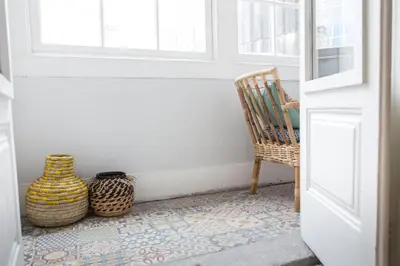 a door with a chair and vases on a floor at Porto República Suites in Porto