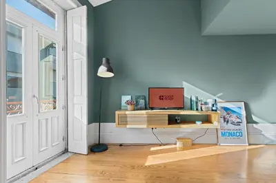 a room with a desk with a television on it at GuestReady-Cozy Duplex in Porto's Vibrant Heart in Porto