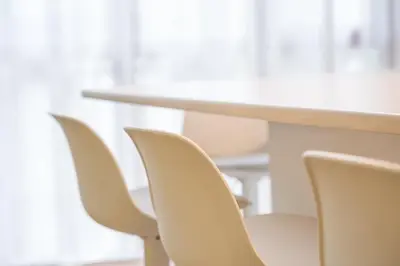 a row of white chairs next to a table at GuestReady - Charming Studio in Porto Centre in Porto