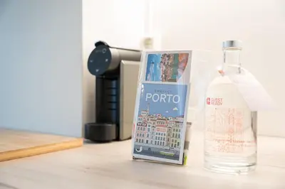 a bottle of vodka and a bottle of water on a table at GuestReady - Charming Studio in Porto Centre in Porto
