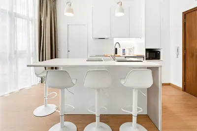 a bedroom with a bed and a white table at GuestReady - Charming Studio in Porto Centre in Porto