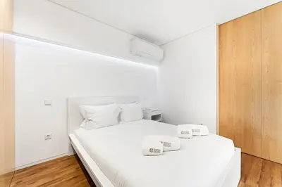 a bedroom with a white bed with two white pillows at GuestReady - Urban comfort in Boavista in Porto