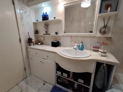 a kitchen with a counter with a microwave and a window at Guest House Douro in Vila Nova de Gaia