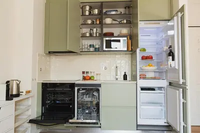 a kitchen with an open refrigerator and an oven at Apartment 1 min walk from Metro and Trendiest Neighborhood Bonfim in Porto