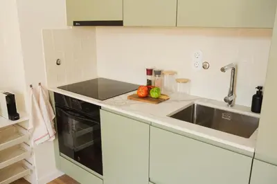a kitchen with a sink and a counter top at Apartment 1 min walk from Metro and Trendiest Neighborhood Bonfim in Porto
