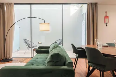 a living room with a green couch and a table at Liiiving in Porto - The Prestige Apartment C in Porto