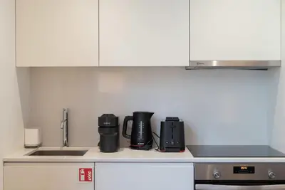 a kitchen counter with a coffee maker and appliances at Liiiving in Porto - The Prestige Apartment C in Porto
