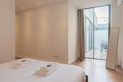 a living room with a green couch and a lamp at Liiiving in Porto - The Prestige Apartment C in Porto