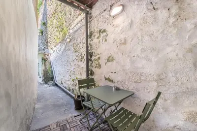 a table and chairs in a room with a wall at GuestReady - charming retreat in Porto in Porto