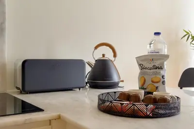 a counter with a bottle of milk and a basket of food at Magnolia 3 Luxury with AC Metro Downtown Porto in Porto