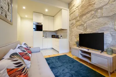 a living room with a couch and a flat screen tv at Luxury Style 8 with AC Downtown Porto near Metro in Porto