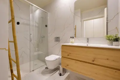 a bathroom with a shower and a toilet and a sink at Luxury Style 8 with AC Downtown Porto near Metro in Porto