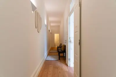 a hallway leading to a living room with a table at Almada 559 - Eça Atelier by Lisbeyond in Porto